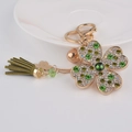 Portachiavi a quadrifoglio dorato con strass verdi e nappa in pelle coordinata - Verde
