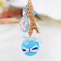 Portachiavi macaron azzurro con torre Eiffel dorata e ciondolo a ciambella - Celeste