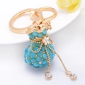 Creative sky blue cat eye stone money bag keychain with gold chain and crystals - Blue