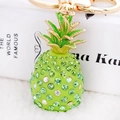 Green crystal pineapple keychain with gold hardware on a gift box background - Green Pineapple (CHY-2773/4742/4192)