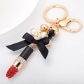 Portachiavi a rossetto con strass rossi, perle e fiocco nero con finitura dorata - Rosso