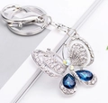 Funkelnder Schmetterlings-Schlüsselanhänger mit blauen Kristalltropfen und Karabiner - See Blau
