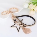 Llavero de estrella en oro claro con borla, estrella negra hueca y bola de cristal - Negro