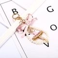 Portachiavi ballerina rosa con figura dorata, perle e fiocco per decorazione borsa - Rosa