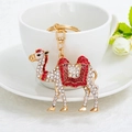 Exotic camel keychain pendant with white and red crystals on golden alloy frame - Red