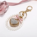 Elegant heart keychain with rhinestones, pearls and a pink silk bow on gold metal - Gold