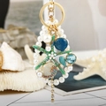 Llavero de estrella de mar y concha con perlas, estrella verde y colgante azul - Estrella de Mar Verde