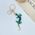 Portachiavi a forma di lucertola verde con strass blu e chiusura dorata - Verde