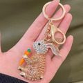 Handheld bunny keychain featuring champagne rhinestones and bright orange carrot accessory - Champagne