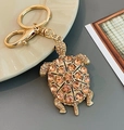 Llavero de tortuga dorada con grandes pedrería de champán y circonitas brillantes - Champán