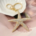 Llavero de estrella de mar dorada con pedrería brillante y cierre de mosquetón - Dorado