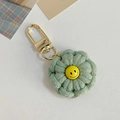 Handmade crochet smiley sunflower keychain in sage green with a golden metal hook clasp - Green