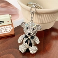 Sparkling crystal bear keychain with black bowknot and silver clasp on wooden background - Black (Silver)