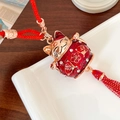 Maneki Neko car charm with red tassels, gold enamel cat, and lucky character ornament - Red