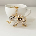 Golden elephant keychain with sparkling rhinestones and enamel heart floral patterns - White