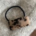 Detailed view of handmade acetate tortoiseshell pattern hair tie on plush background - Light Leopard Square Hair Tie