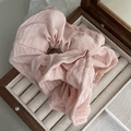 Detail of light pink pleated scrunchie with ribbed texture in a wooden jewelry box - Pink