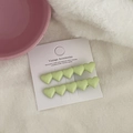 Close-up of two light green heart-shaped hair clips on white display card packaging - Light Green Heart