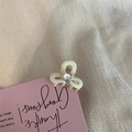 Close-up of mini cream-white hair claw clip with heart-shaped rhinestone on a pink card - White with White Heart / White