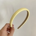 Close-up of cream-colored faux leather padded headband with sponge cushioning detail - Padded PU Leather Style / Yellow