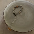 Detailed macro view of handmade woven cord bracelet with ceramic and wooden beads - Brown (Black and White Texture Pendant Bracelet)