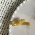 Detailed close-up of France Handmade engraving on a cream ribbon knot hair clip - Pure Yellow