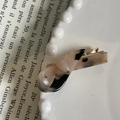 Detailed macro view of France Handmade lettering on a tortoise shell pattern hair clip - Light Leopard
