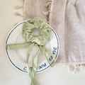 Elegant light green satin scrunchie with long ribbons on a decorative white plate - Satin Scrunchie Streamer / Green