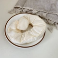Off-white puffer scrunchie with silky finish displayed on elegant ceramic plate - Creamy White Puffer