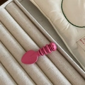 Cute pink shovel shaped hair clip with cartoon face on beige jewelry display tray - Rose Red