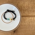 Black elastic hair tie with colorful enamel letters and a small metal charm in a ceramic dish - 10# Black Hair Rope Three Letter Style