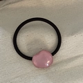 Minimalist pink pebble hair tie on canvas background with elastic black rope - Transparent Pink Irregular Round Hair Rope