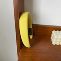 Detailed shot of yellow padded headband with handmade label on wooden shelf - Yellow