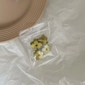 Detail shot of four mini flower hair claws in matte olive green finish with packaging - Olive Green
