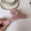 Détail de la grande pince à cheveux en peluche rose poudré avec texture bouclée - Rose