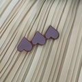 Detail view of purple heart-shaped acetate hair clip with gold lettering on soft fabric - Purple Three Hearts Style (9#)