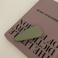 Close-up of matte grass green teardrop hair clip on a purple designer fashion book - Waterdrop Shape (4#Green) / Green