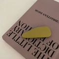 Close-up of olive green matte leather hair clip on a stylish purple book background - Waterdrop Shape (3#Ginger) / Turmeric
