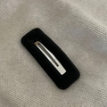 Detailed close-up of a black velvet-covered rectangular hair clip on a knitted fabric backdrop - Black Rectangle Flocking Hair Clip
