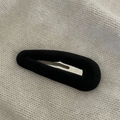 Close-up of black velvet waterdrop hair clip on white knitted texture background - Black Water Drop Flocking Hair Clip