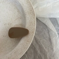 Close-up of a brown acetate water drop hair clip on a minimalist ceramic plate - Solid Coffee Triangle