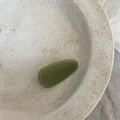 Detail of an olive green acetate water drop hair clip on a minimalist ceramic tray - Solid Green Triangle