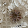 Macro shot of colorful wool felt ball telephone wire hair tie on white lace fabric - Plain Ring - Coffee