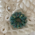 Close-up of green wool felt hair tie with colorful speckles on vintage lace fabric - Plain Ring - Green