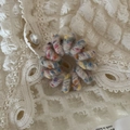 Close-up of a colorful braided spiral hair tie on a delicate white lace background - Plain Ring - Off White