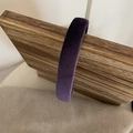 Detailed texture of the thick velvet padded headband in dark purple displayed on wood - Purple (2cm)