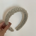 Close-up of thick beige plush sponge headband featuring textured bouclé fabric for winter - Beige Grey