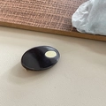 Detailaufnahme einer ovalen Acetat-Haarklammer mit goldenem Metalllogo und Clipverschluss - 1# Braun mit Gold-Tag
