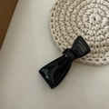 Detail of black bow hair clip featuring golden France Handmade lettering on acetate - Black Bow Hair Clip