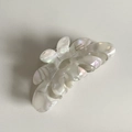 Detail of French handmade floral acetate hair claw with iridescent mother of pearl finish - Grey White Textured Curved Claw Clip